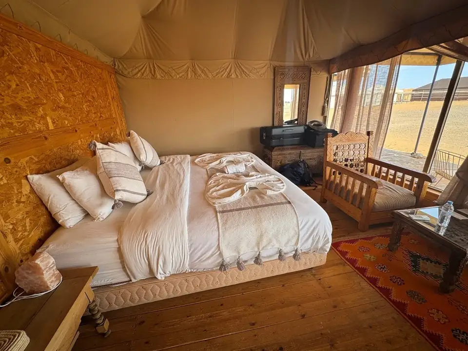 Luxury tent with king-size bed at Milagro Luxury Camp in Merzouga